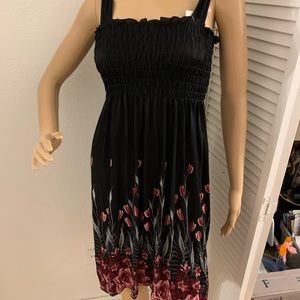 Black sun dress with rose print at the bottom. Brand new with tags. Small/medium